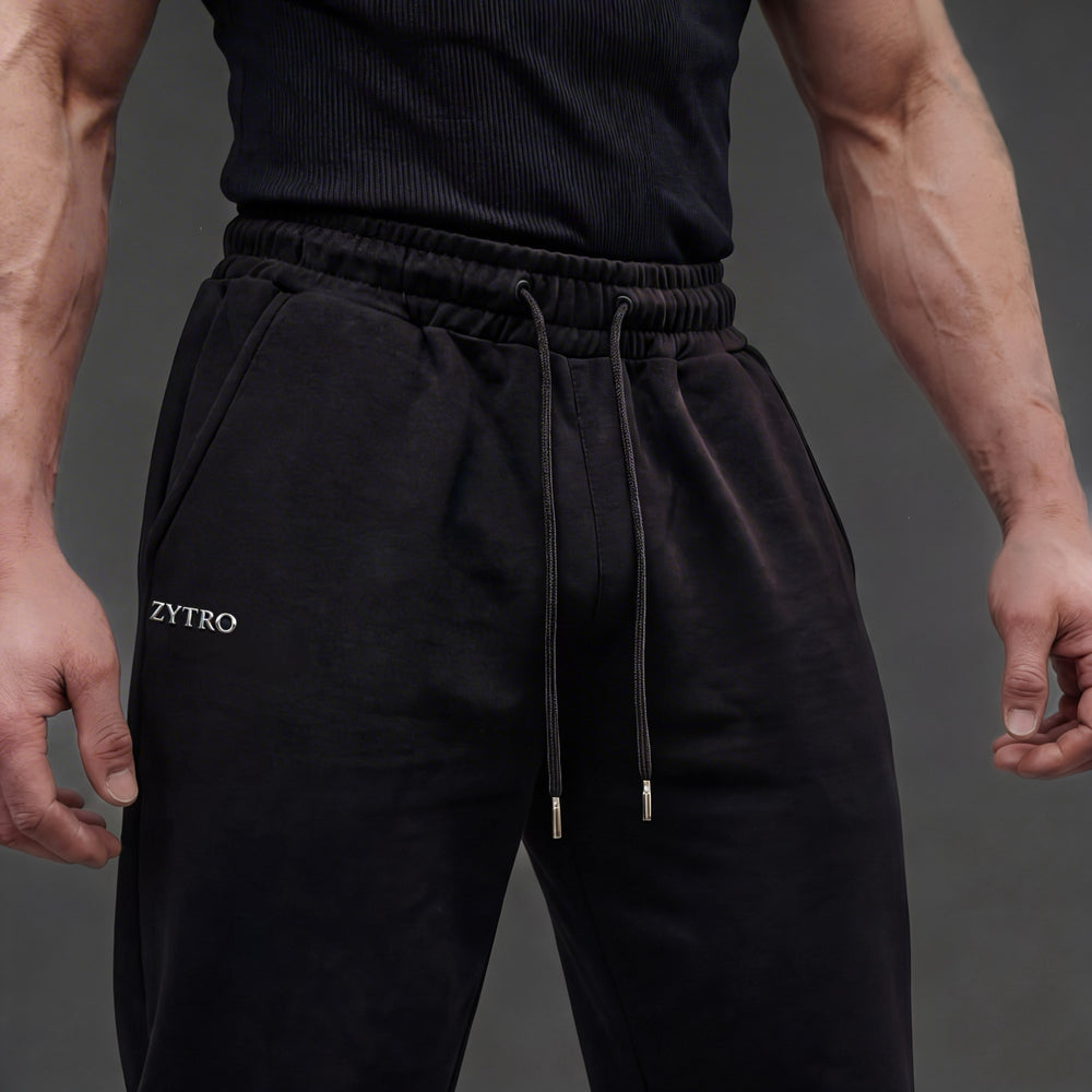 Front close up view of legacy uncuffed joggers, 100% french terry cotton, silicone ZYTRO transfer in silver finish.